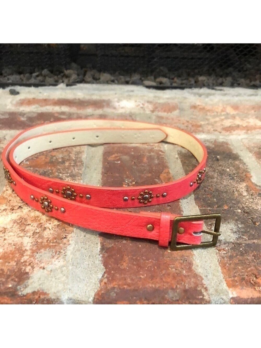 Women’s 3/4” wide coral belt with burnished gold tone and silver tone studs. 36”